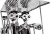 A close-up of a metal sculpture of two figures in a golf cart. Podgląd zdjęcia produktu