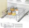 A wire pull-out cabinet organizer with jars of pasta inside, shown partially pulled out of a cabinet. A separate wire basket and screws are shown below. Náhľad obrázku produktu