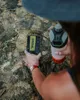 A person is using a GRAYL water purifier in a stream. Podgląd zdjęcia produktu