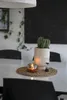 A table setting with a cactus in a pot, a candle, and an hourglass. Produktbild-Vorschau