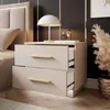 A bedside table with two drawers, a lamp, and decorative items. Produktbild-Vorschau