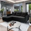 A modern living room with a sectional sofa, coffee table, and stairs.