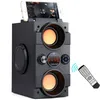 A black Bluetooth speaker with a smartphone docked on top, and a remote control with signal waves emanating from it. Podgląd zdjęcia produktu