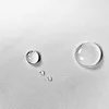 Close-up of water droplets on a textured fabric surface. Podgląd zdjęcia produktu