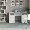 A white desk with a laptop, lamp, and chair in a room with gray walls and a bookshelf. Produktbild-Vorschau