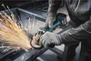 A person is using an angle grinder to cut metal, creating a lot of sparks. Náhľad obrázku produktu