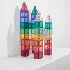A colorful castle-like structure made of translucent magnetic building tiles is displayed on a white surface against a white background. Podgląd zdjęcia produktu