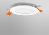A white LED downlight with orange clips is shown against a light gray and white background. Produktbild-Vorschau
