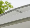 Close-up view of an outdoor awning or canopy structure, showing the metal frame and white fabric. Produktbild-Vorschau