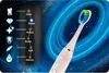 A pink electric toothbrush with a multi-colored brush head is shown against a dark, starry background with glowing blue rings. To the left, a vertical display shows different brushing modes with icons and labels. Náhled obrázku produktu