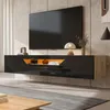 A modern living room with a wall-mounted TV cabinet and a large television. Podgląd zdjęcia produktu