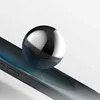 A close-up shot of a silver sphere resting on the edge of a black smartphone. Anteprima dell’immagine prodotto