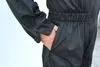 A close-up shot of a person's hand in the pocket of a black jumpsuit. Náhled obrázku produktu