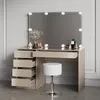 A vanity table with a mirror and stool in a room. Voir les images du produit