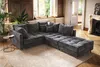 A sectional sofa in a living room setting with plants and a fireplace. Produktbild-Vorschau
