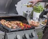 A person is pouring oil onto food being grilled on a barbecue. Náhled obrázku produktu
