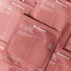 A pile of pink face mask packaging. Náhľad obrázku produktu
