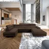 A spacious, modern living room with a large sectional sofa, dining area, and kitchen. Produktbild-Vorschau