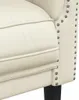 Close-up view of the armrest and seat cushion of a cream-colored armchair. Produktbild-Vorschau