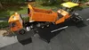 A dump truck is connected to a road paver on a street. Produktbild-Vorschau