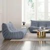 A modern living room with a blue sofa and a matching armchair. Anteprima dell’immagine prodotto
