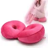 A person sitting on a pink cushion, with two pink cushions in the foreground. Produktbild-Vorschau