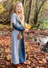 A young girl in a medieval-style dress stands in a forest during autumn. Produktbild-Vorschau