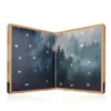 An open advent calendar with a forest scene on the inside panels. Produktbild-Vorschau