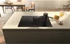 A modern kitchen island with an integrated induction cooktop and downdraft ventilation system. Podgląd zdjęcia produktu