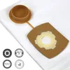 A close-up view of a vacuum cleaner bag with a cap and a cardboard adapter. Produktbild-Vorschau
