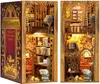 A diorama of a miniature bookstore inside a book-shaped casing, shown from two different angles. Voir les images du produit