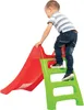 A young boy is climbing up a red and green plastic slide. Anteprima dell’immagine prodotto