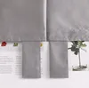 A close-up view of gray fabric curtains with text and images visible underneath. Produktbild-Vorschau