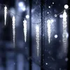 Icicle lights are strung across a window with a snowy or frosty effect. Náhled obrázku produktu
