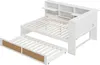 A white wooden daybed with a trundle bed pulled out, showing the slatted mattress bases and a bookcase headboard. Voir les images du produit