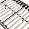 A close-up view of the slatted base of a bed frame, showing the wooden slats and the black metal support structure. Náhľad obrázku produktu