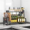 A kitchen counter with a two-tier spice rack organizer holding various bottles and jars, a cutting board, and knives. Produktbild-Vorschau