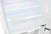 Interior view of an empty white refrigerator with clear shelves and drawers. Produktbild-Vorschau