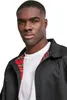 A man wearing a black jacket with a plaid lining. Anteprima dell’immagine prodotto