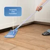 A person is using a mop to clean a wooden floor in a room with white cabinets. Produktbild-Vorschau