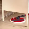 A Vileda Spin & Clean floor mop is being used to clean under a piece of furniture. Podgląd zdjęcia produktu