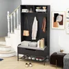 A hallway or entryway with a coat rack and bench against a wall, next to a staircase. Podgląd zdjęcia produktu