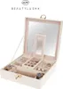 An open jewelry box with various compartments and jewelry inside, including watches and earrings. The box has a mirror inside the lid. Náhled obrázku produktu