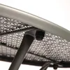 A close-up view of the underside of a round table, showing the metal frame and perforated surface. Náhľad obrázku produktu