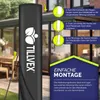 A black umbrella cover with instructions on how to use it, set against a blurred outdoor background of a patio and garden. Anteprima dell’immagine prodotto