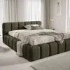 A modern bedroom with a large upholstered bed. Náhled obrázku produktu