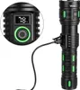 A close-up view of a black Vayox flashlight with green accents, showing a digital display indicating 78% battery life and a USB charging cable connected. Produktbild-Vorschau