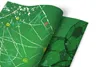 A close-up, angled view of a green furniture sticker with a soccer field pattern and soccer balls. The sticker is partially unrolled. Produktbild-Vorschau
