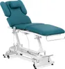 A turquoise electric massage table with a white metal base, shown from a side-diagonal angle against a white background. Náhled obrázku produktu