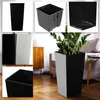 A collage of images showing different views and details of black and gray planters, including a lifestyle shot of a planter with a plant in a living room. Anteprima dell’immagine prodotto